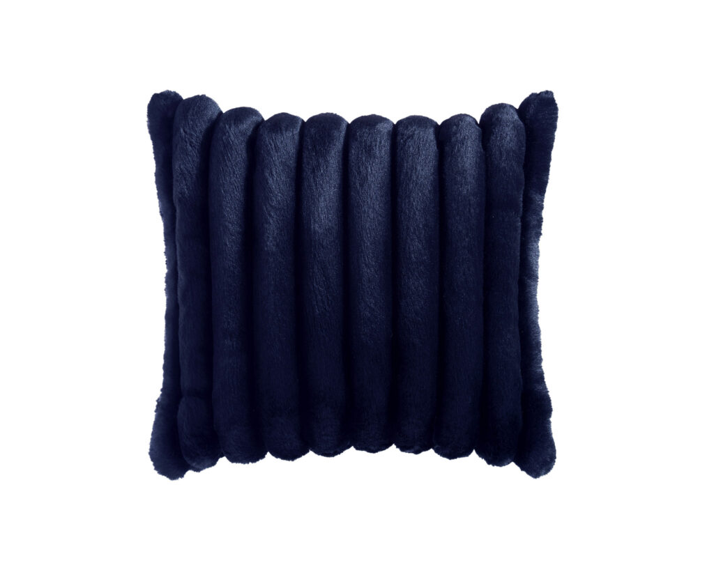 Close-up of dark blue velvet fringe trim with soft, rounded tassels along a fabric edge