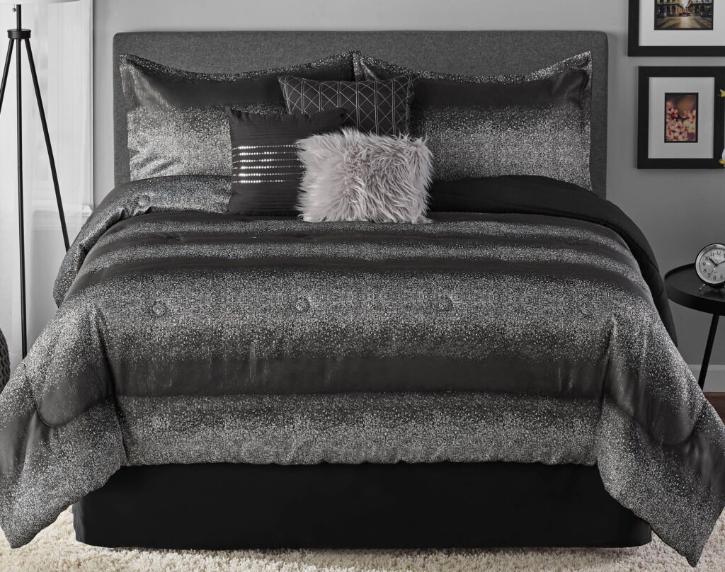 Bed with a glittery silver duvet and matching pillows, plus a fluffy gray throw pillow in a modern bedroom.
